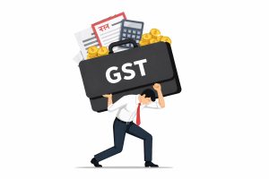 Rahul Gandhi speaking at a public event while criticising the GST tax structure and discussing its impact on small businesses in India.